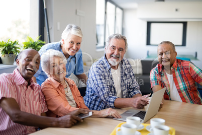 Portrait of smiling practitioner with senior people