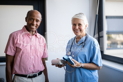 Portrait of smiling senior man and healthcare worker