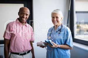 Portrait of smiling senior man and healthcare worker