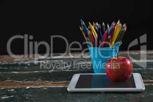 Apple on digital tablet with pen holder