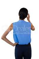 Rear view of confused businesswoman with head in hand
