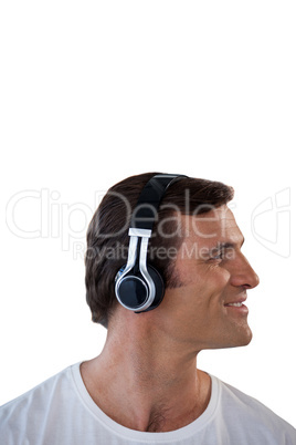Smiling mature man listening music through headphones