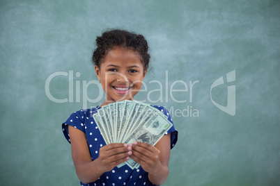 Happy girl showing paper currency
