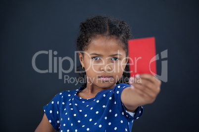 Close up portrait of girl showing red card