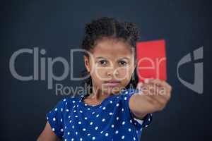 Close up portrait of girl showing red card