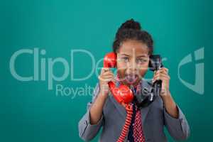 Portrait of surprised businesswoman talking land line phones