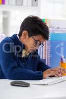 Businessman wearing eyeglasses while using desktop computer