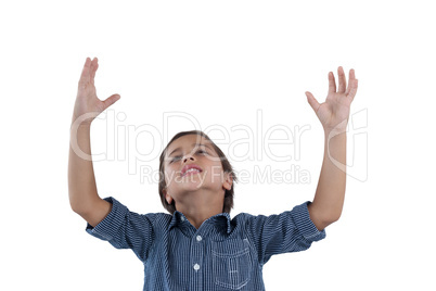 Cute boy standing with hands raised