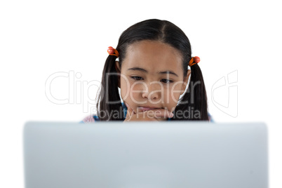 Thoughtful girl using laptop
