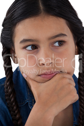 Girl with hand on chin against white background