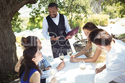 Friends placing order to waiter