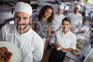 Restaurant manager with his kitchen staff