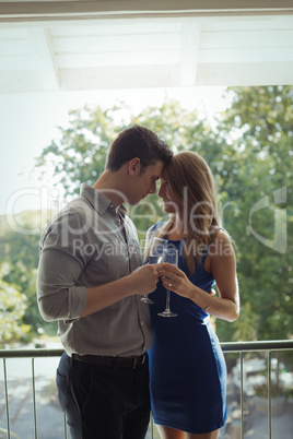 Couple toasting champagne glasses in restaurant