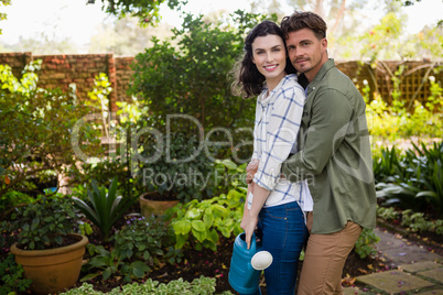 Portrait of couple embracing each other in garden