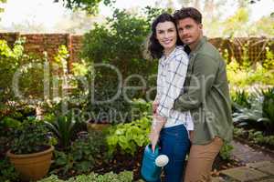 Portrait of couple embracing each other in garden