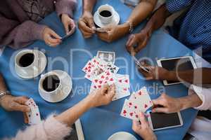 Overhead view of senior people playing cards
