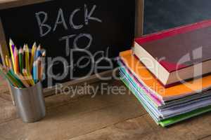 Text written on slate with school supplies