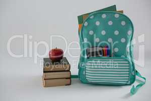 Apple, books and schoolbag on white background