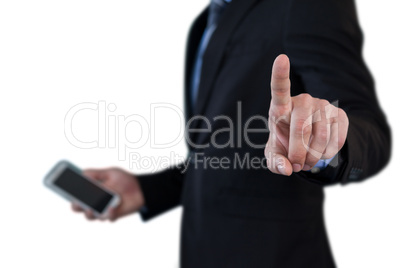 Mid section of businessman holding smartphone while using invisible interface