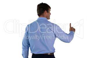 Rear view of businessman in blue shirt using invisible interface