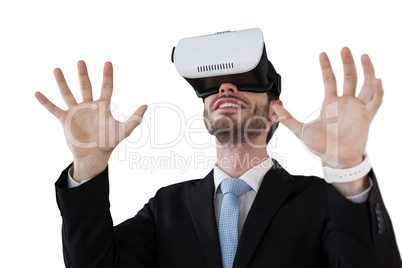 Businessman with vr glasses gesturing against white background