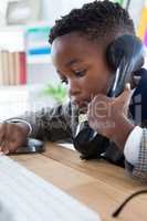 Close up of businessman talking on land line phone