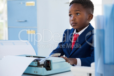 Businessman looking away while sitting at desk