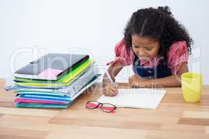 Smiling businesswoman writing on book