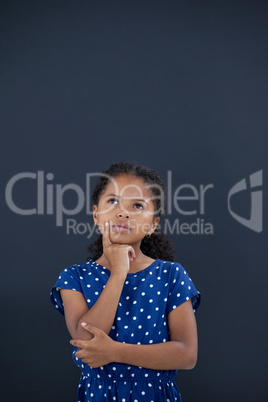 Contemplated girl with hand on chin