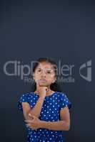 Contemplated girl with hand on chin