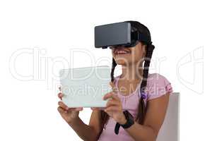 Teenage girl using virtual reality headset and digital tablet