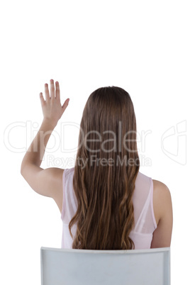 Girl pressing an invisible virtual screen against white background