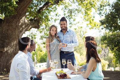 Group of friends interacting with each other while having champagne