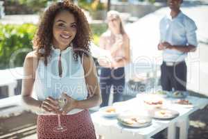 Smiling woman holding glass of wine in restaurant