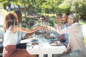 Group of friends toasting glasses of wine in a restaurant