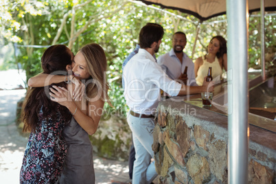 Friends embracing each other at counter