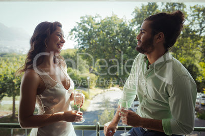 Couple interacting with each other while having champagne