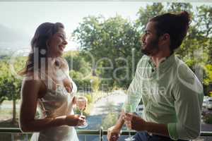 Couple interacting with each other while having champagne