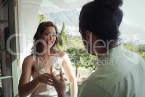 Couple interacting with each other while having champagne