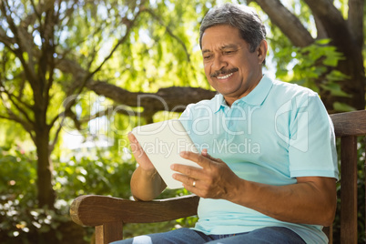 Senior man using digital tablet