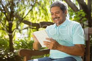 Senior man using digital tablet