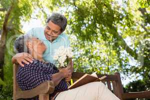 Senior man giving flowers to woman