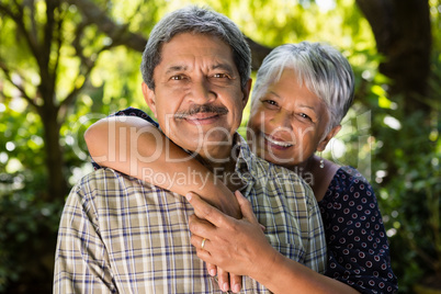 Senior couple holding hands in garden