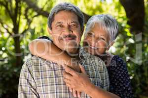 Senior couple holding hands in garden