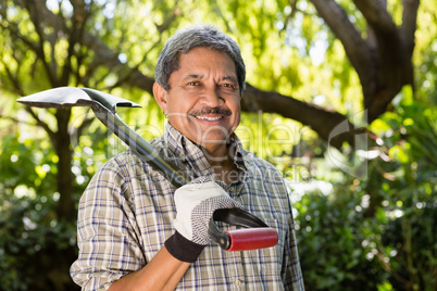 Senior man standing in garden on a sunny day