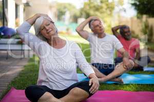 Senior people stretching heads while exercising