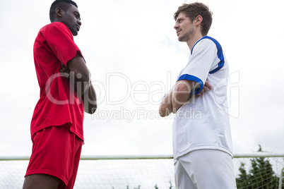 Low angle view of young male soccer players looking at each other