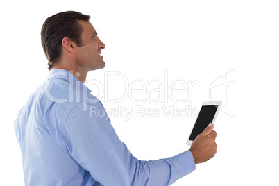 Side view of businessman using digital tablet