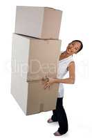 Portrait of smiling businesswoman carrying stack of cardboard boxes