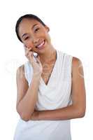Portrait of happy businesswoman with head cocked using mobile phone